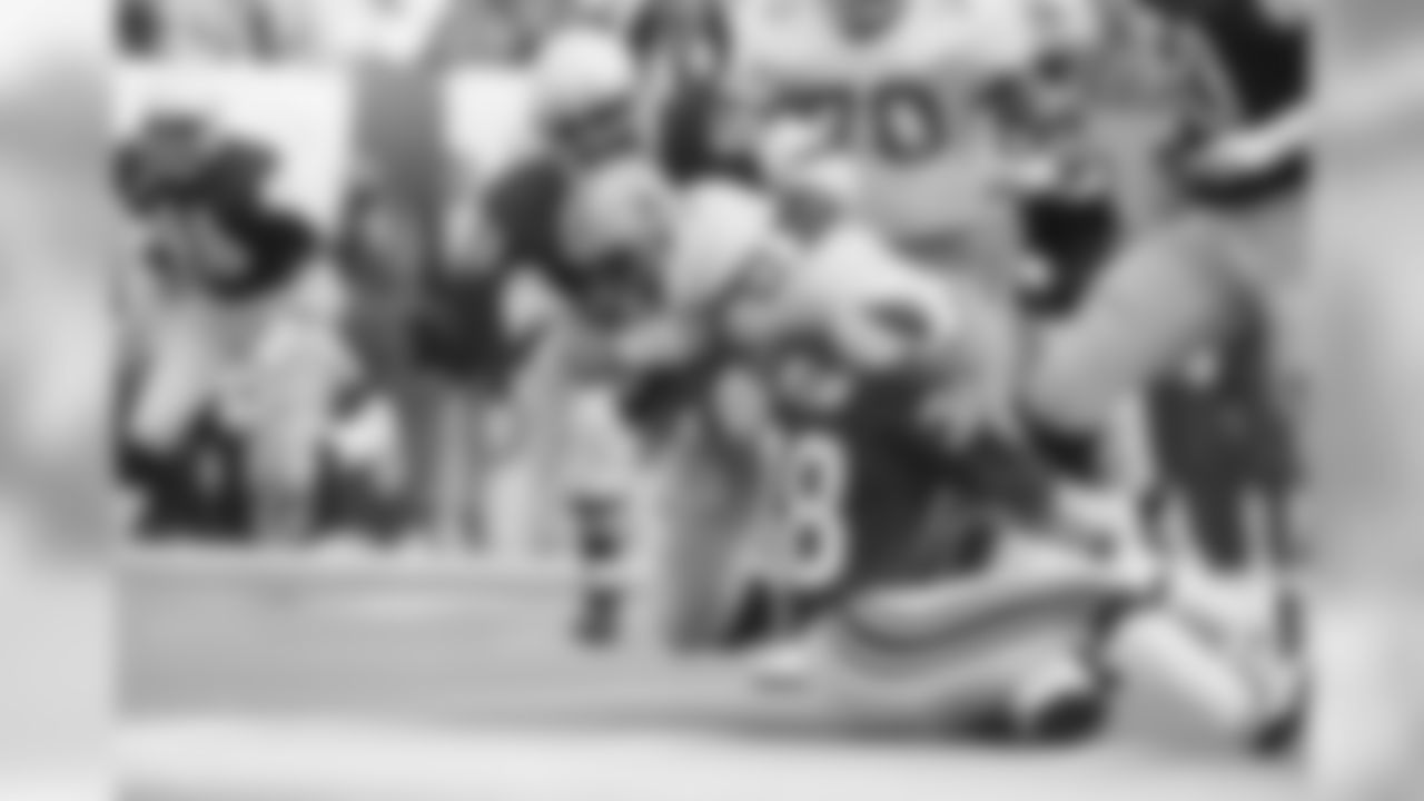 1983: S Lee Nelson and LB Charlie Baker (52) tackle Cowboys RB Tony Dorsett