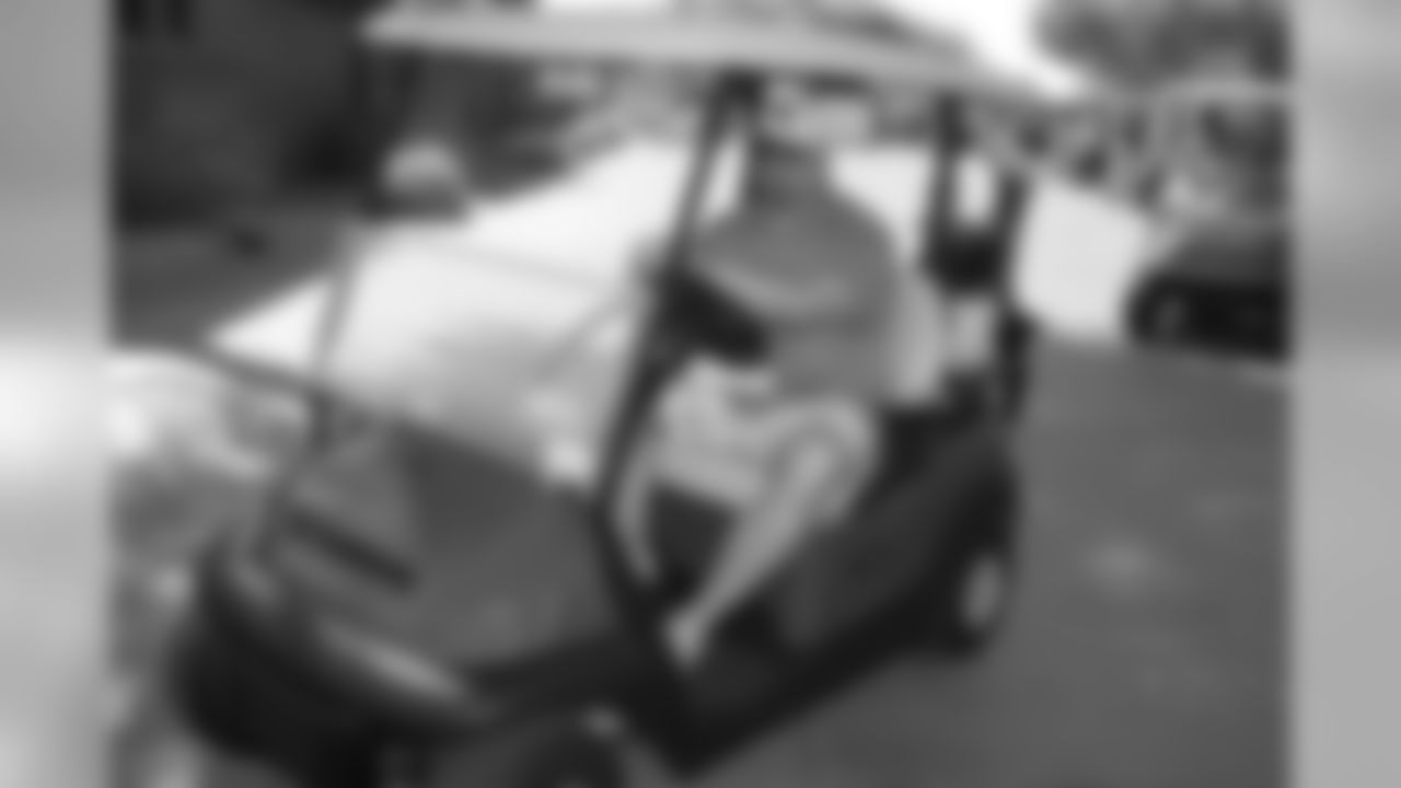 GM Steve Keim driving a golf cart.