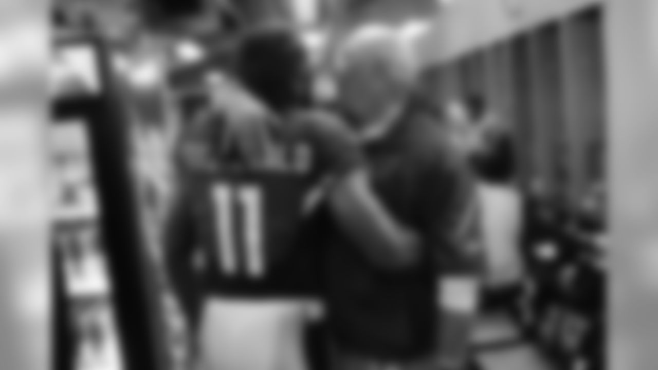WR Larry Fitzgerald hugs coach Bruce Arians.