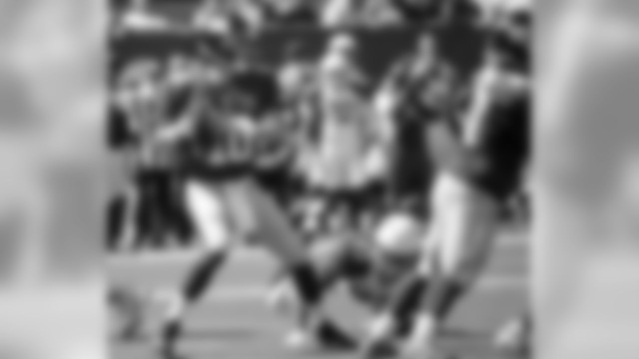 Giants QB Eli Manning drops back as DE Calais Campbell lunges for his leg