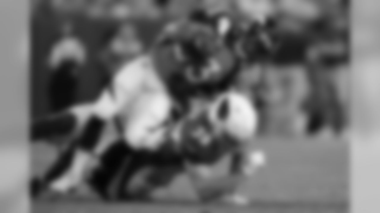 Arizona Cardinals defensive back Tyler Sigler (39) trips up Denver Broncos running back Khalfani Muhammad (33) during the second half.