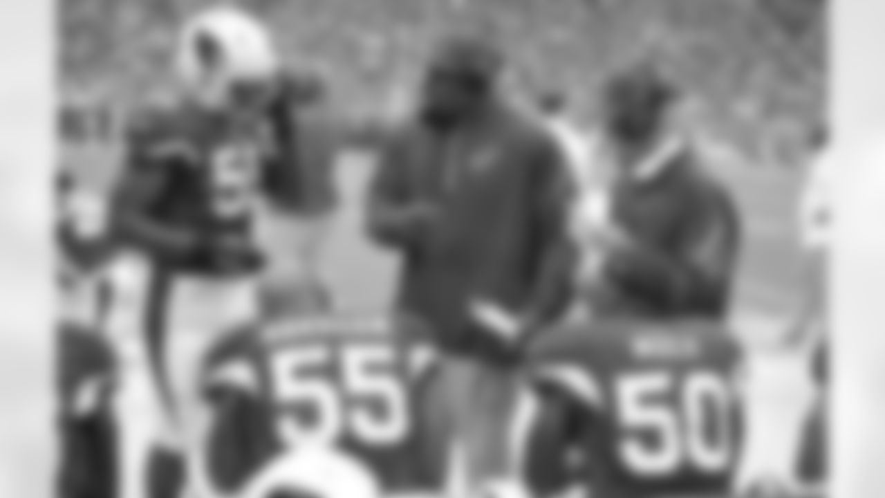 Defensive line coach Brentson Buckner (middle) and pass-rush specialist Tom Pratt (right)