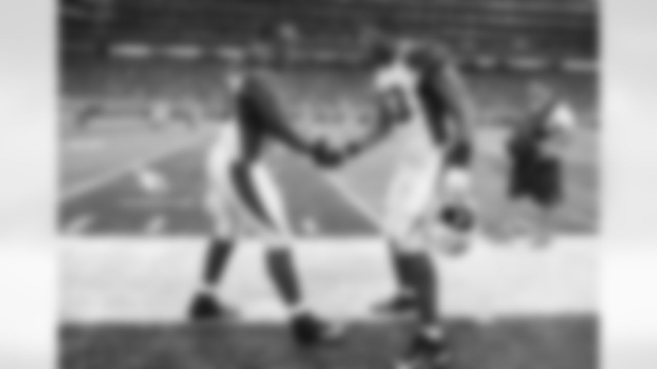 DT Cory Redding (left) gets congratulated by DT Calais Campbell after an interception