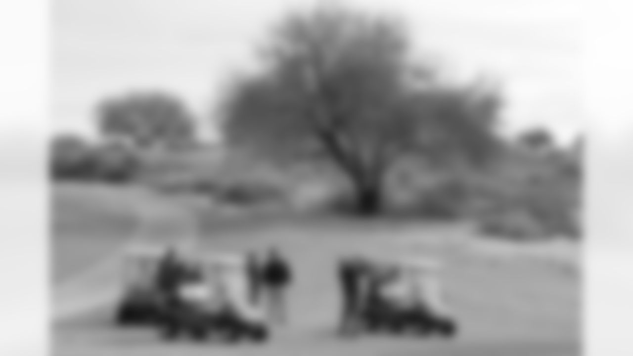 A participant takes an approach shot