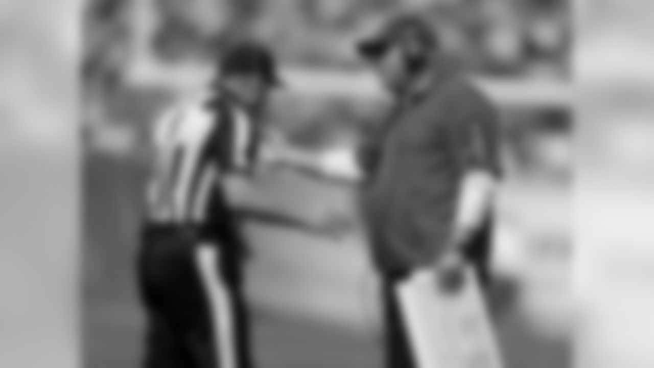 Coach Bruce Arians talks to an official
