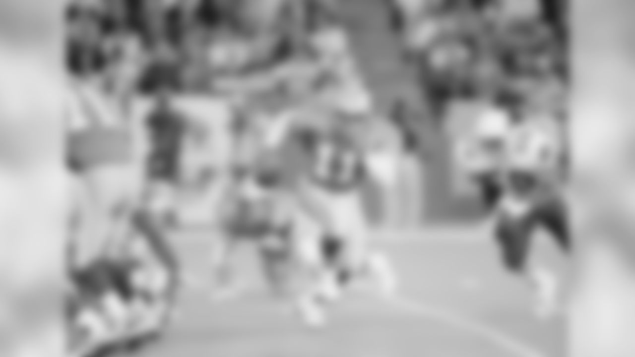Detroit Lions quarterback Andre Ware (11) runs from the pocket trying to avoid the tackle of Phoenix Cardinals outside linebacker Freddie Joe Nunn (50) during the first quarter in Pontiac, Mich., Sept. 26, 1993. Ware lead the Lions to a 26-20 victory by completing 11 of 24 passes for 194 yards.