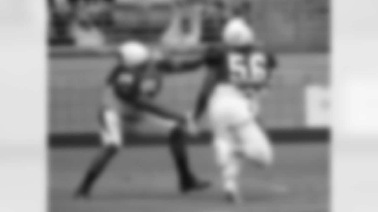 LB Reggie Walker gets around RB Andre Ellington