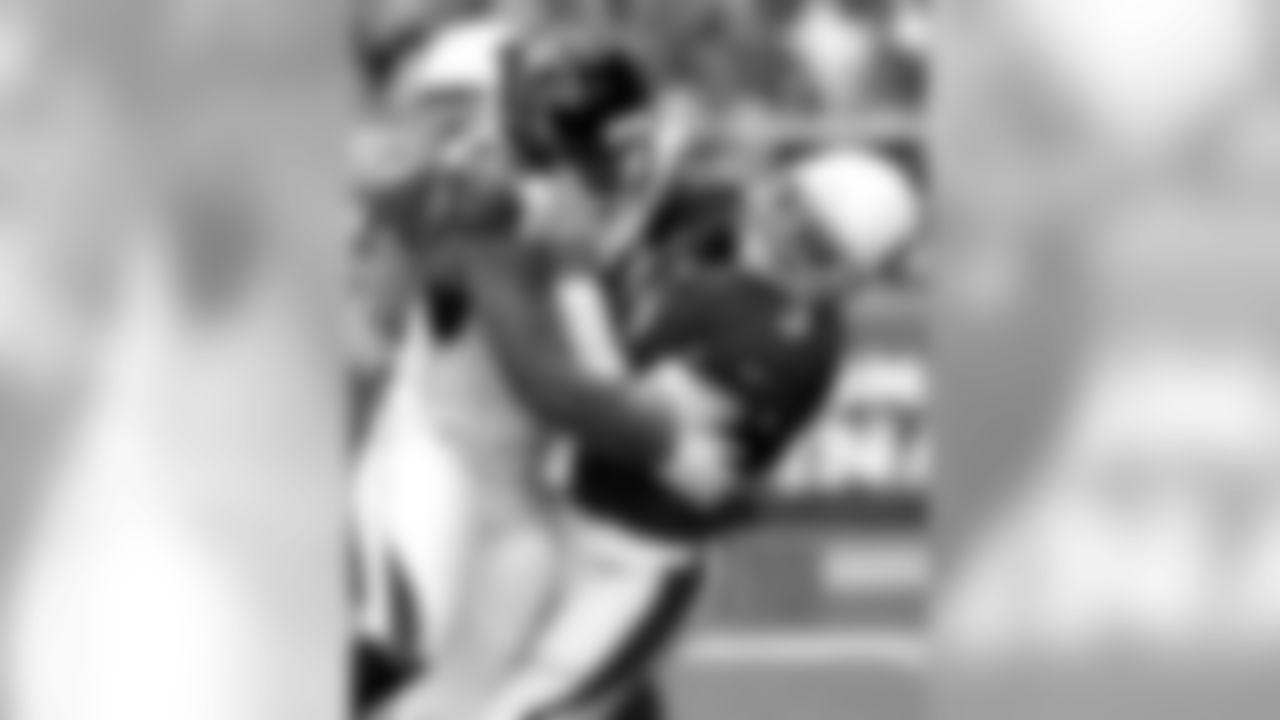 Carson Palmer is hit by Falcons defensive end Osi Umenyiora.