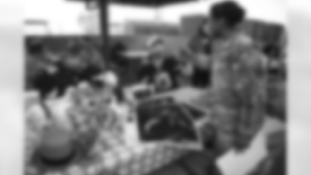Arizona Cardinals Legends and current players serve food and sign autographs at Luke Air Force Base for Feed the Flight Line on Thursday, March 2, 2023 in Glendale, AZ.