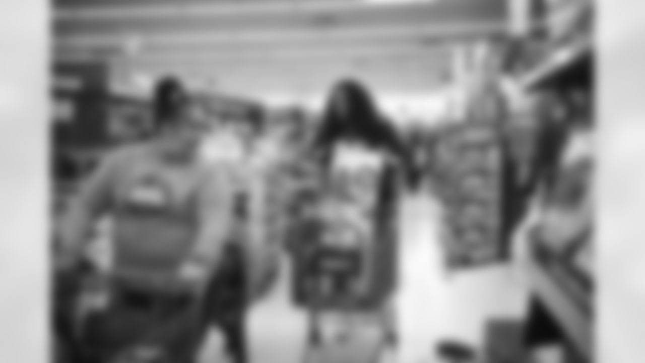 The Arizona Cardinals participate in Shop With A Jock with Desert Financial Credit Union at Walmart on Tuesday, December 13, 2022 in Tempe, AZ.