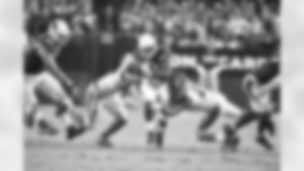 Johnson shakes off a pair of tacklers against the Bengals