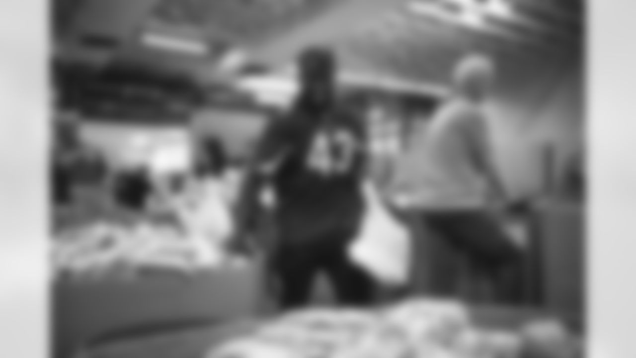 The Arizona Cardinals and Verizon help pack bags of food at United Food Bank on Tuesday, April 4, 2023 in Mesa, AZ.