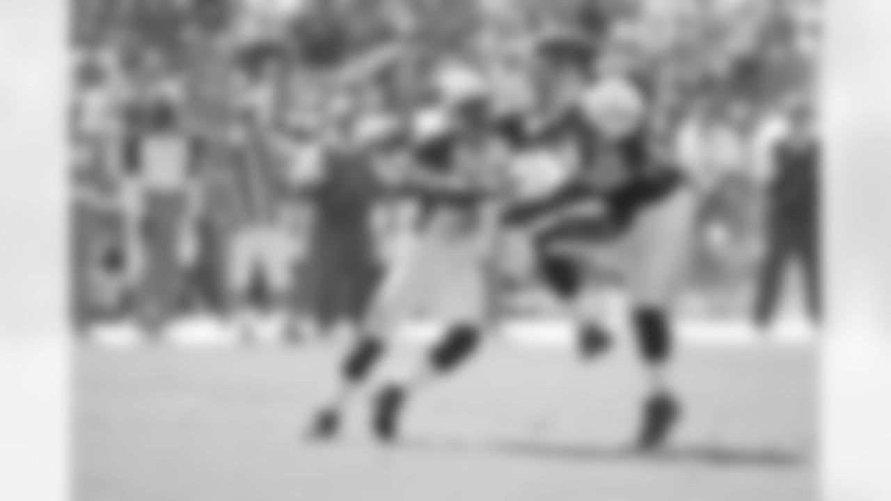 Adrian Wilson pushes Mike Tolbert out of the way