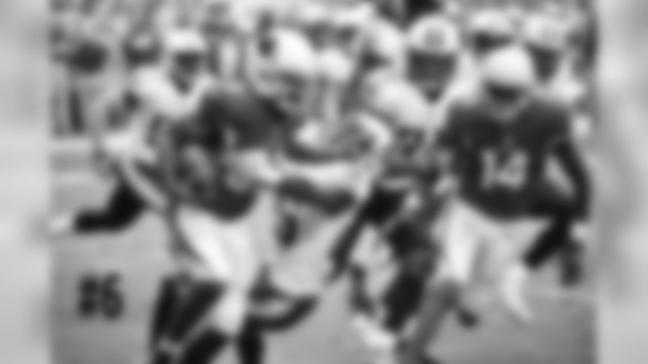 RB Kerwynn Williams delivers a stiff-arm