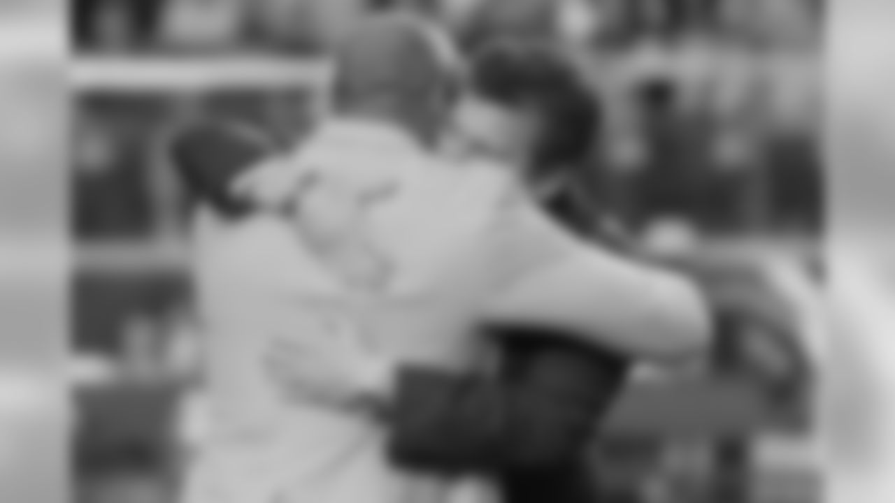 Aeneas Williams hugs team president Michael Bidwill during the presentation