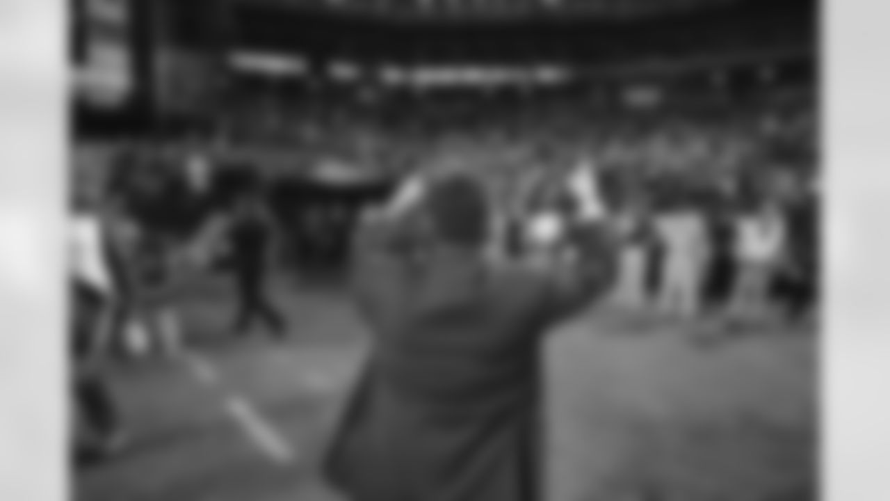 Team president Michael Bidwill points to the crowd after beating the Chiefs