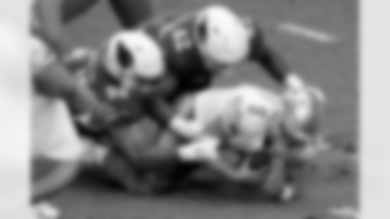 Detroit Lions quarterback Matthew Stafford (9) is sacked by Arizona Cardinals outside linebacker Devon Kennard (42) and defensive tackle Corey Peters (98).