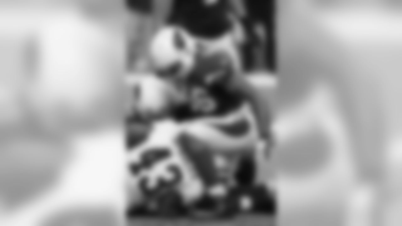 LB Karlos Dansby looks down at Saints RB Darren Sproles after a tackle.