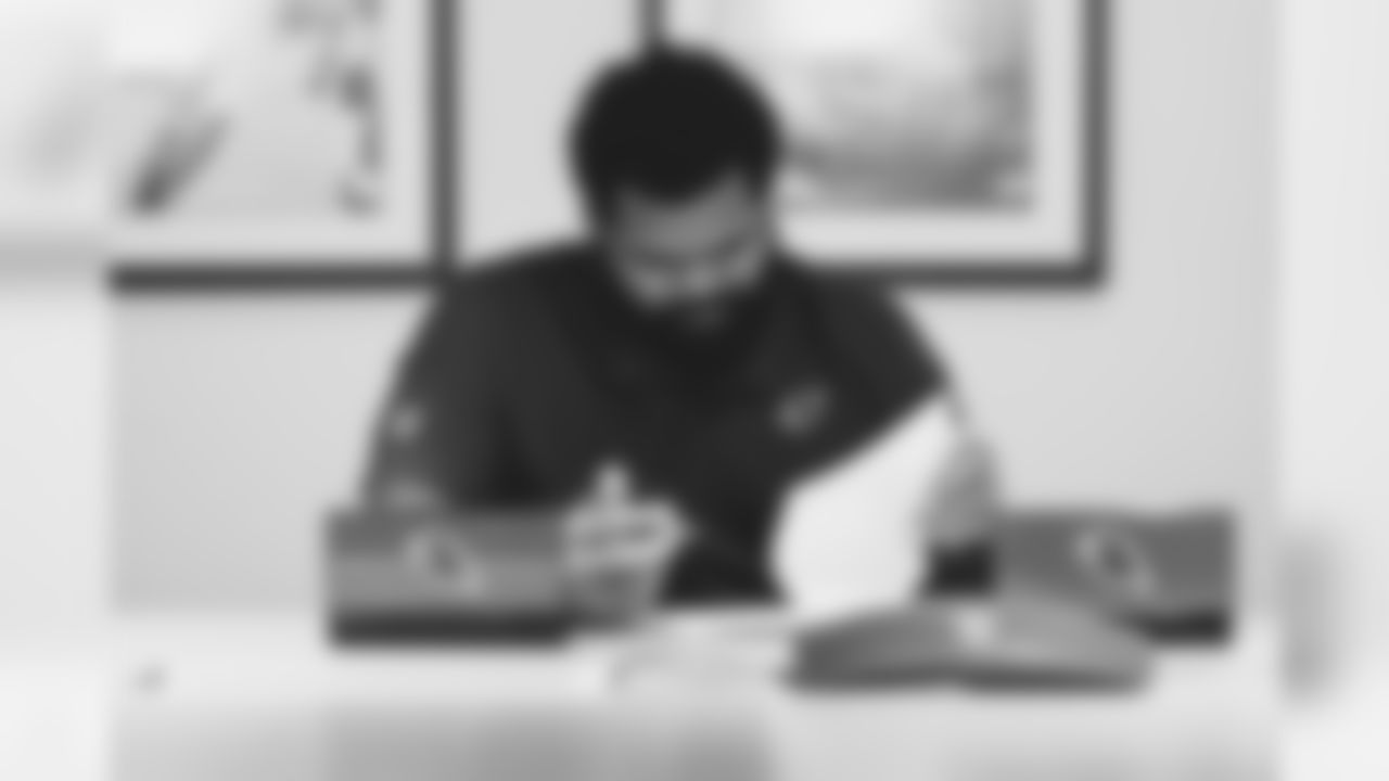 DT Rashard Lawrence looks over his rookie contract.