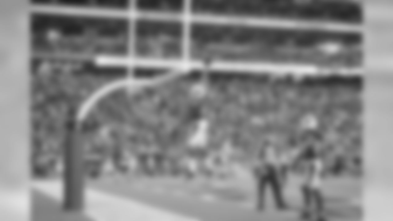 Floyd dunks the ball over the goal post following a touchdown