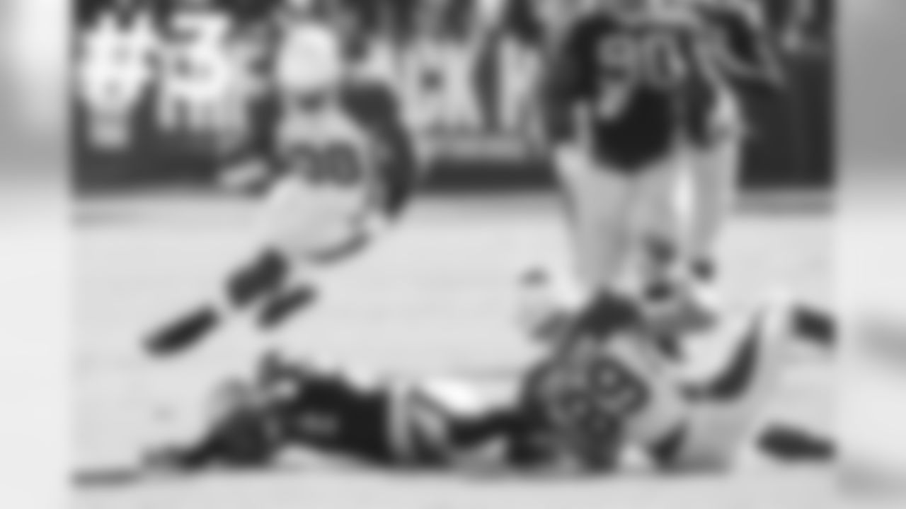 RB Andre Ellington is sent airborne by Raiders S Charles Woodson