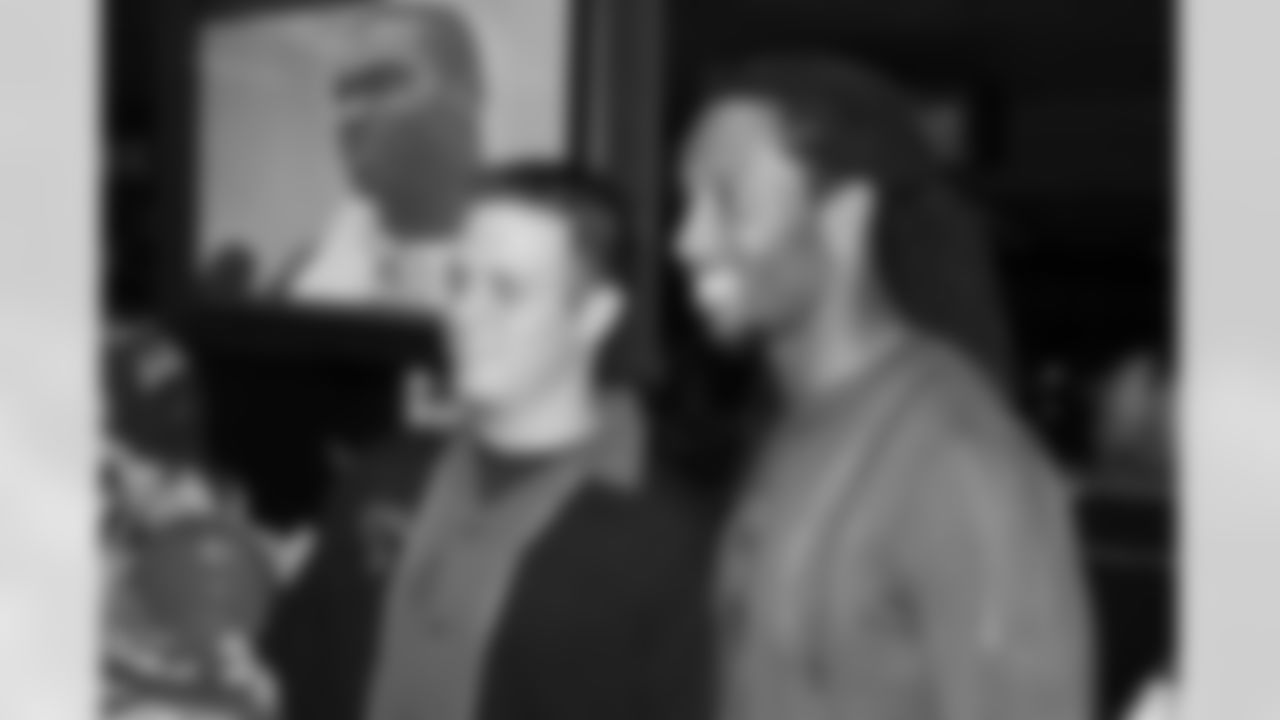 Larry Fitzgerald takes a picture with a fan