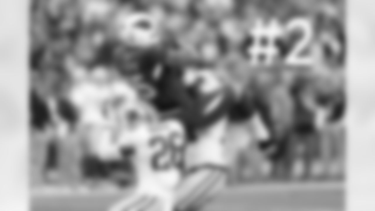 WR Michael Floyd catches a long pass between two defenders.