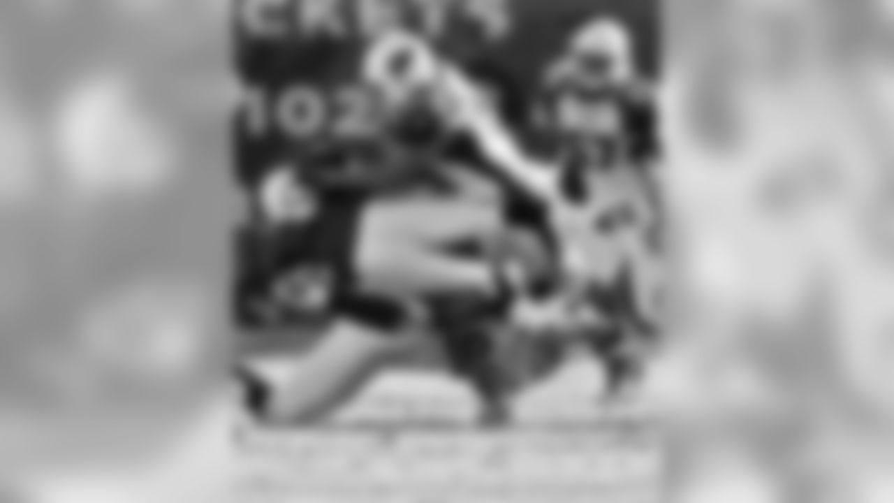 2005: Titans K Rob Bironas is tackled by Darnell Dockett and James Darling.