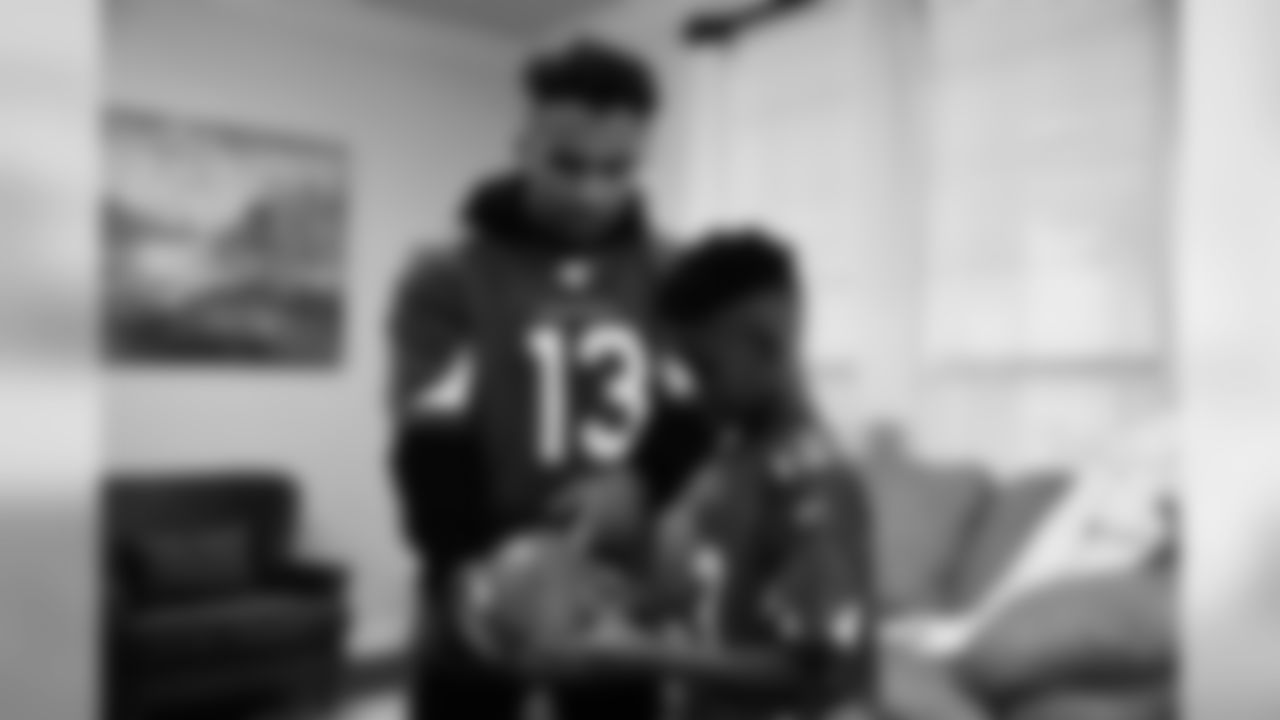 Images of Cardinals receiver Christian Kirk delivering surprise Super Bowl tickets to Devin Manigo at his home in Texas