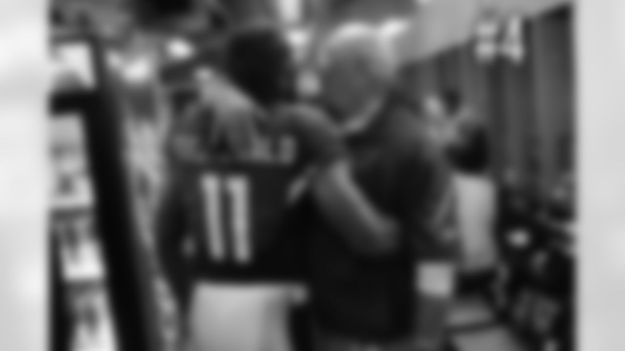 Larry Fitzgerald and Bruce Arians share a moment in the locker room after the win