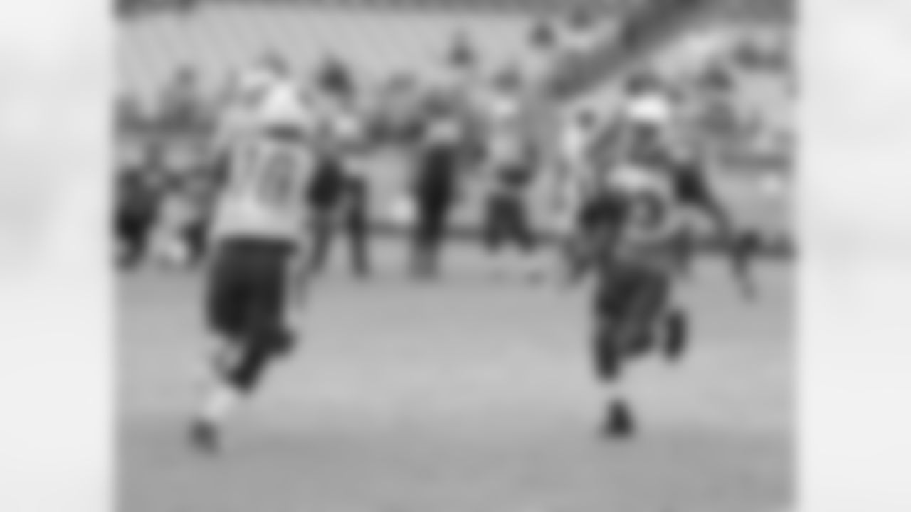 WR Walt Powell (right) flips the ball to WR Brittan Golden
