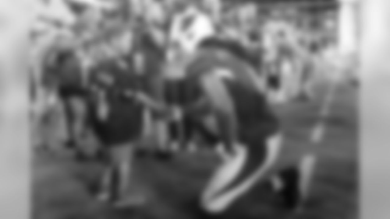 WR Larry Fitzgerald shakes the hand of a young fan.