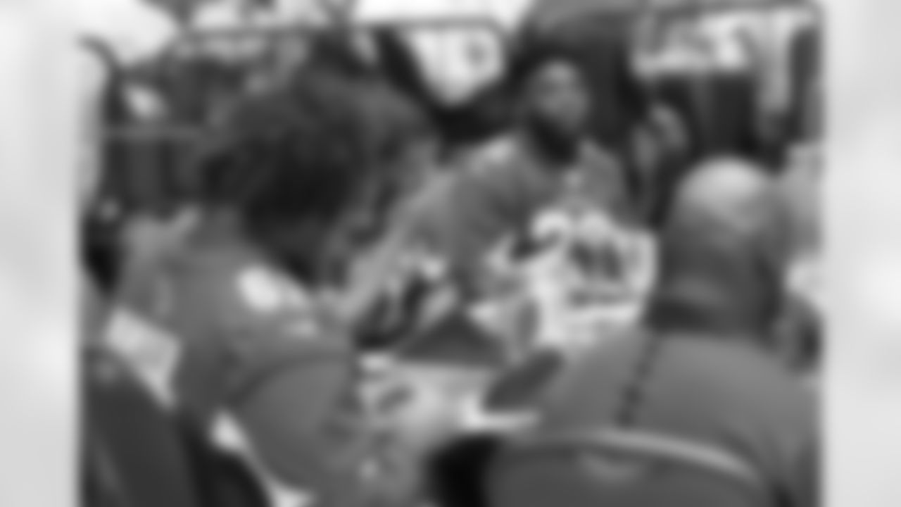 RB T.J. Logan (right) at a table with some Cardinals fans and fellow players