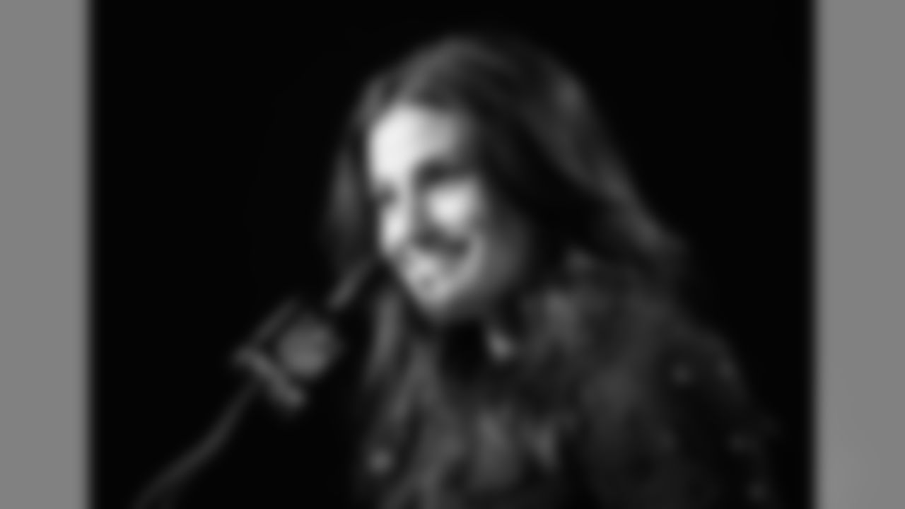 Idina Menzel at a press conference talking about singing the national anthem at the game