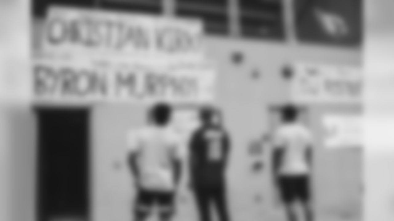 From left: WR Christian Kirk, CB Byron Murphy and RB D.J. Foster check out the 'Welcome Back' signs near the Saguaro locker room
