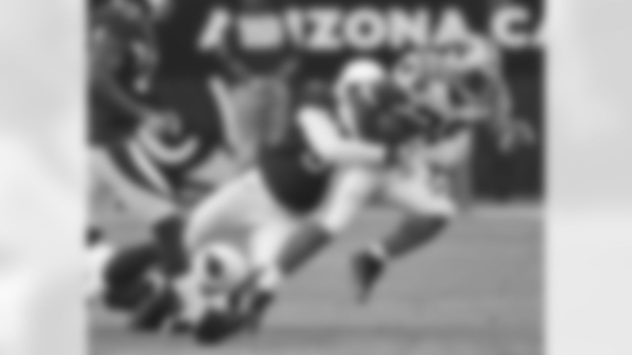 Dansby makes a tackle on Jonathan Stewart in 2009