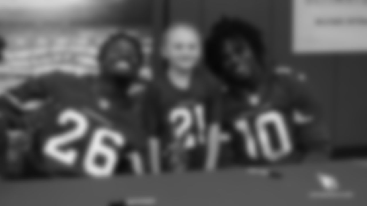 CB Brandon Williams (left) and WR Chad Williams pose for a photo with a young Cardinals fan