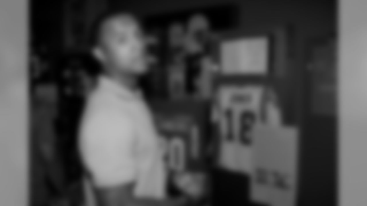Michael Floyd checks out jerseys of Barry Sanders, Charlie Joiner