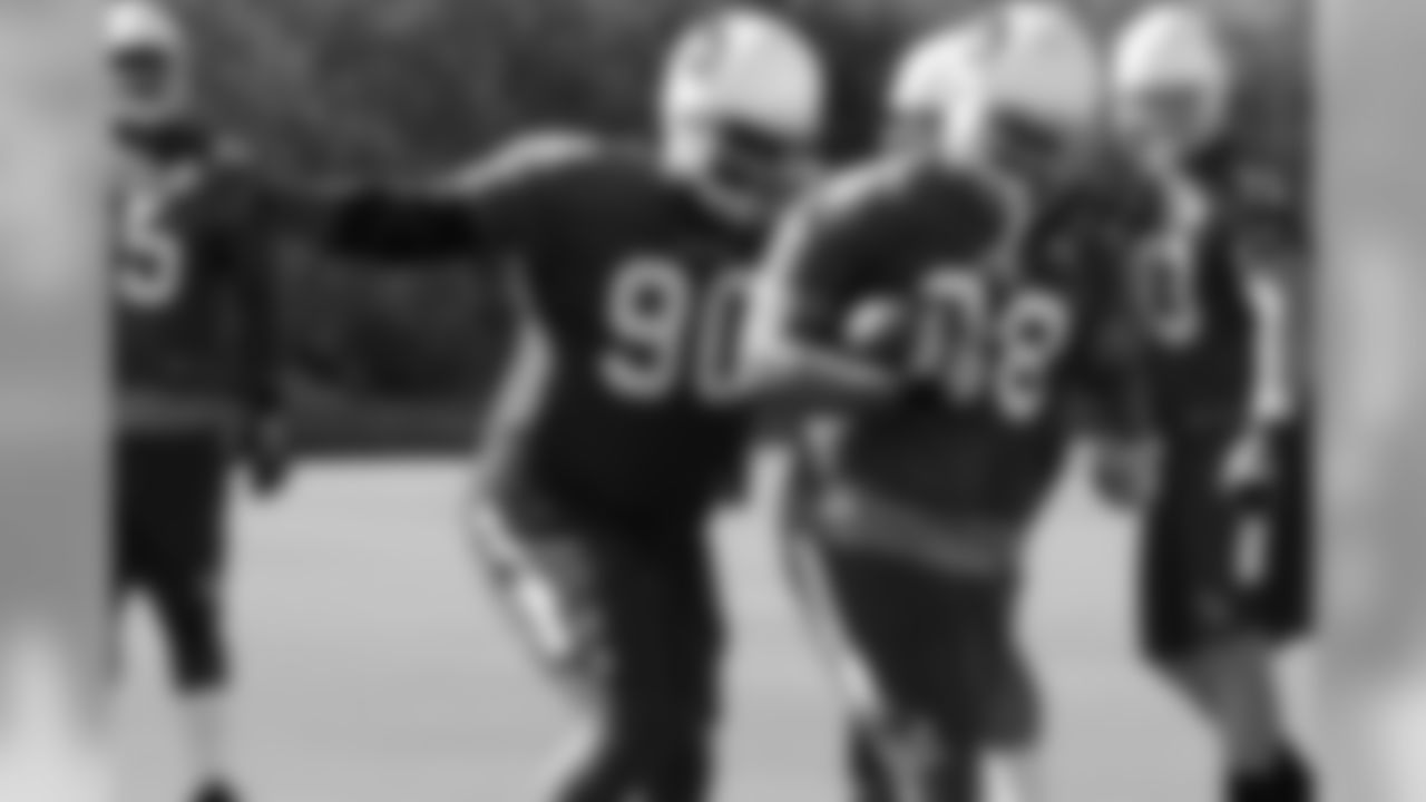 DT Corey Peters goes to strip the ball from DE Cory Redding
