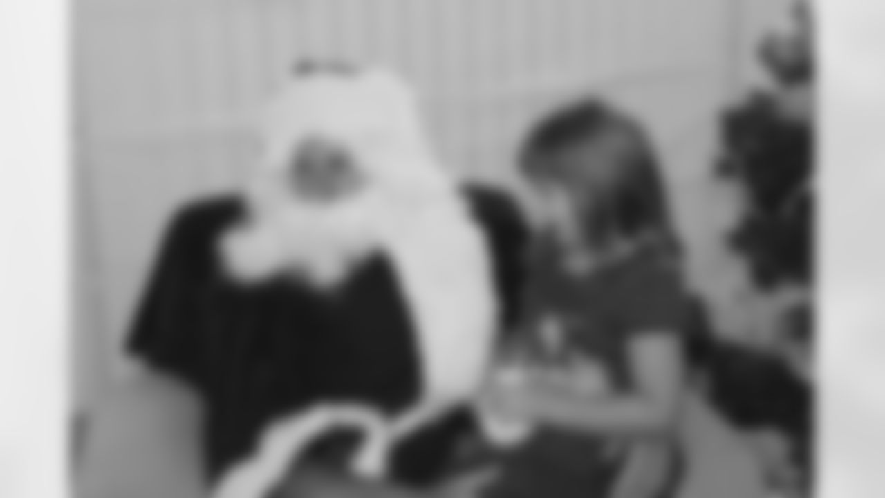 Santa John Lott listens to a girl's wish list