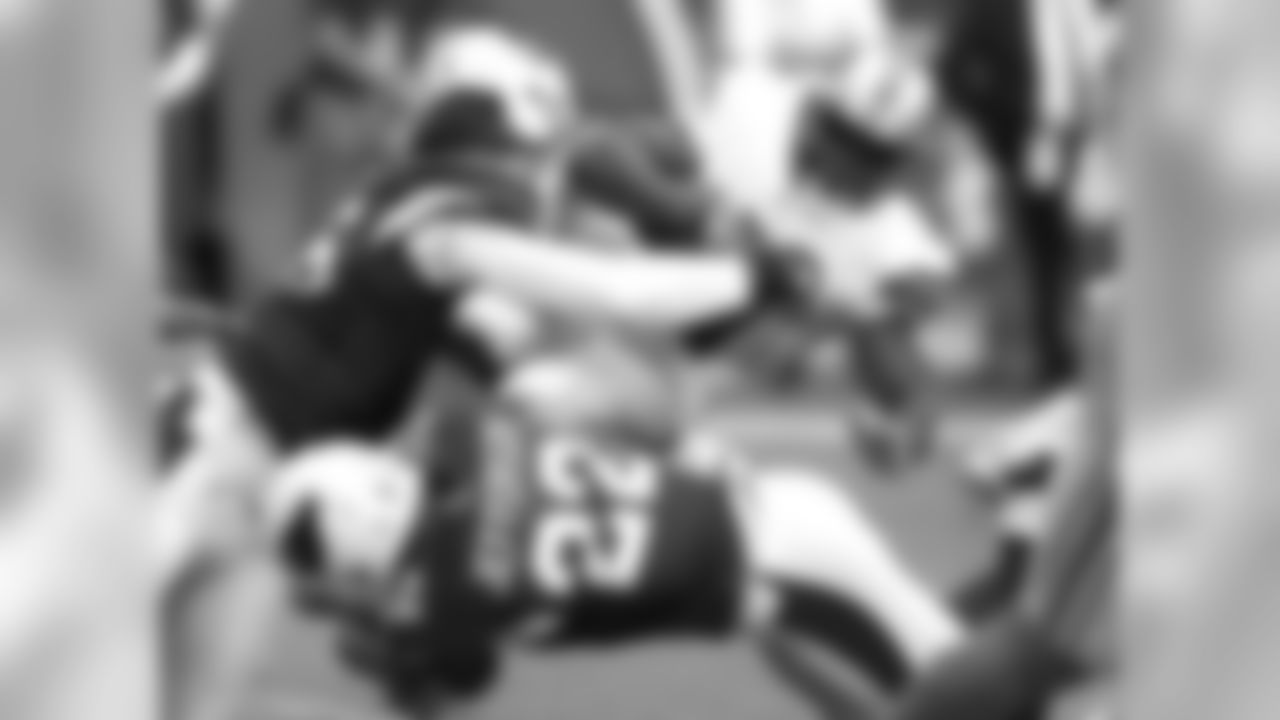 2013: DE Ronald Talley and S Tony Jefferson tackle Lions RB Reggie Bush