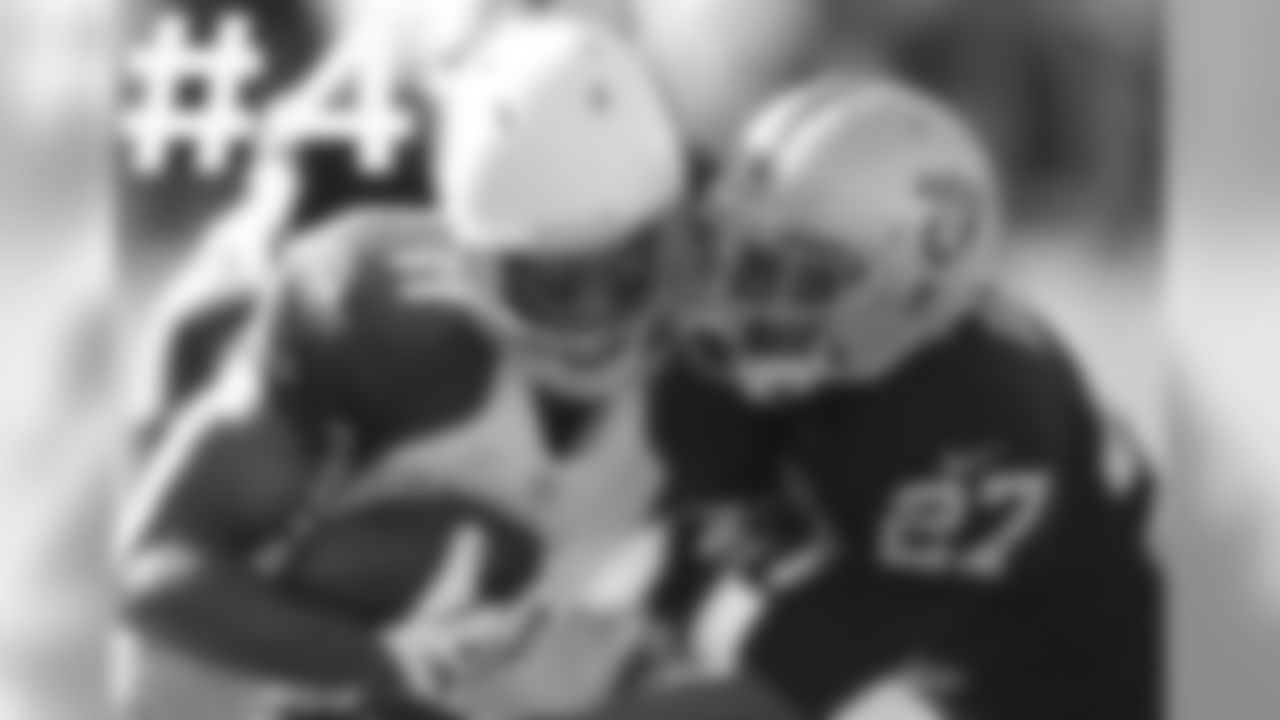 WR Larry Fitzgerald is hit by Oakland CB Carlos Rogers