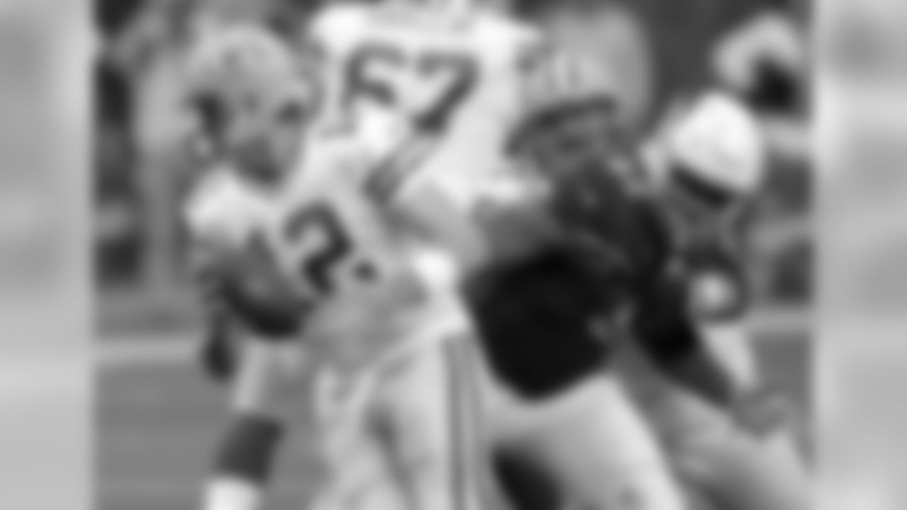 Packers quarterback Aaron Rodgers tries to evade pressure from DT Calais Campbell