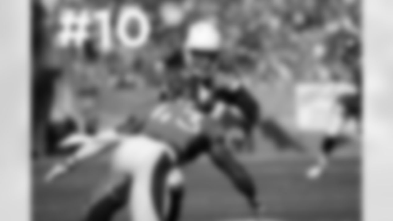 WR Larry Fitzgerald is tackled by Broncos S T.J. Ward