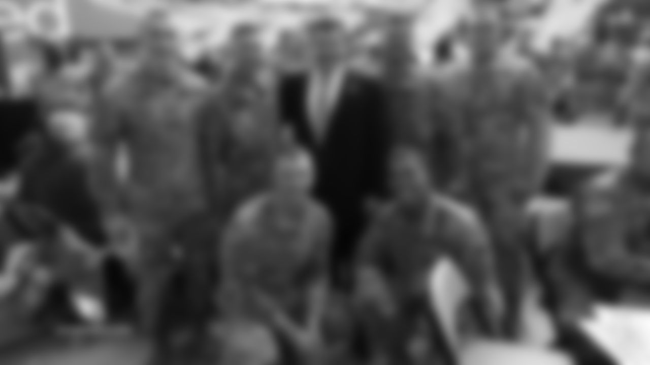 Cardinals team president Michael Bidwill with members of the military inside State Farm Stadium
