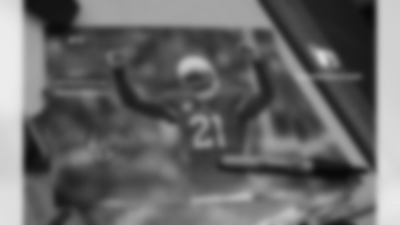Peterson autographs a picture of himself for the school