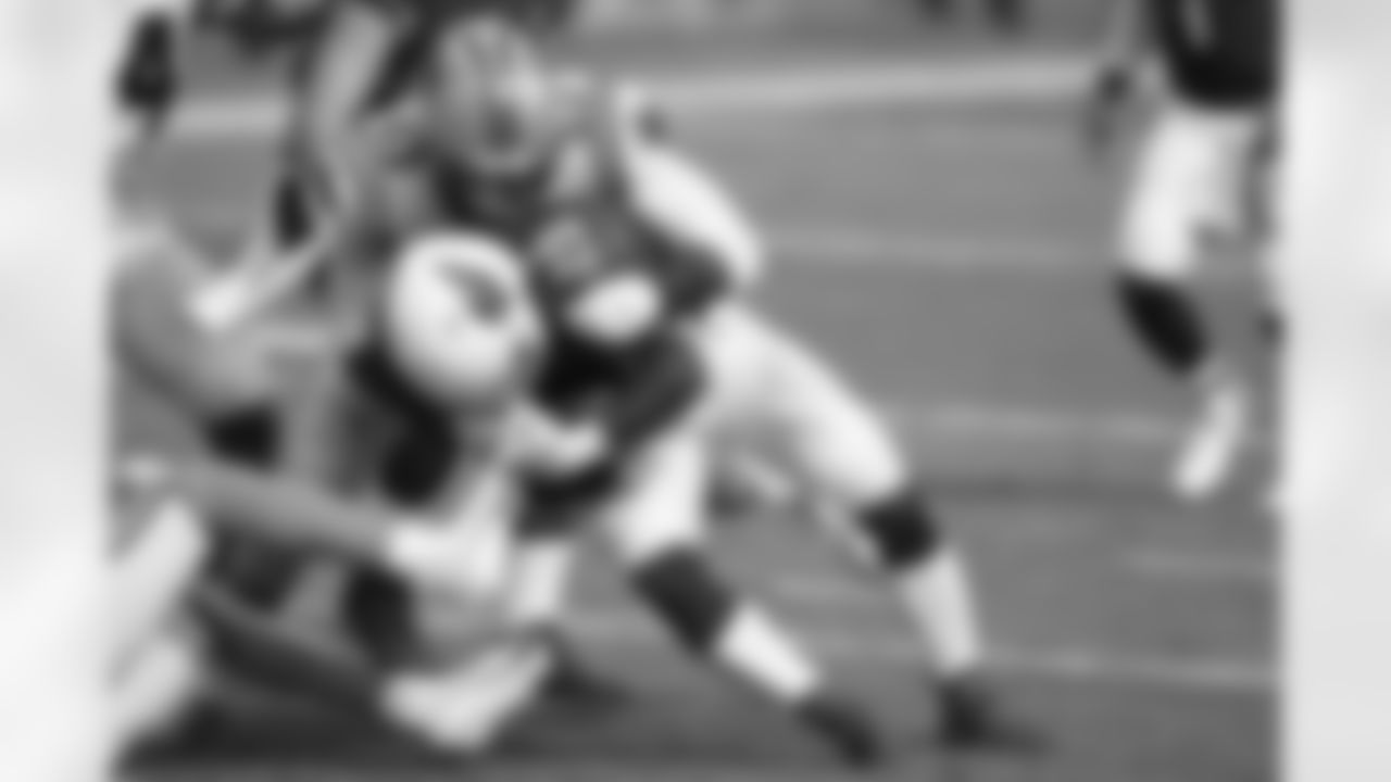 Arizona Cardinals running back Chase Edmonds is tackled by Carolina Panthers defensive end Brian Burns.
