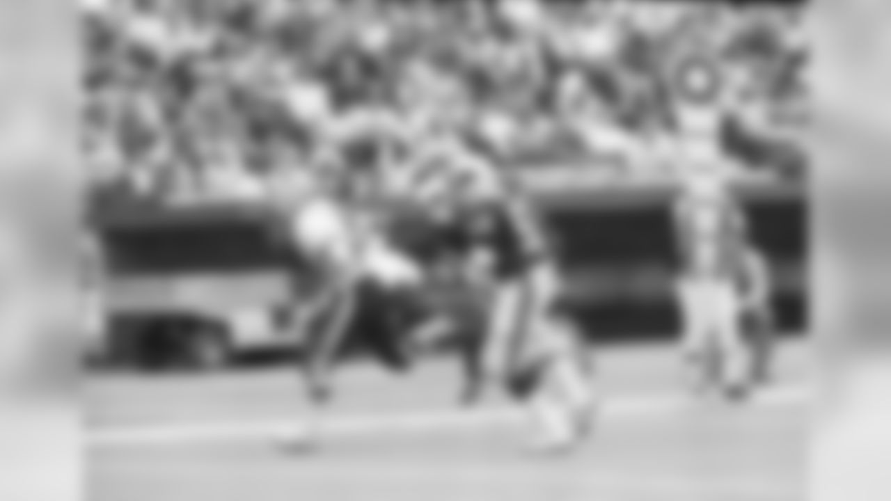 Washington running back John Riggins is followed into the end zone by St. Louis Cardinals Lee Nelson (38) and Charlie Baker (52) during the first quarter of their game in St. Louis, Oct. 9, 1983. Riggins touchdown run was for 17 yards.