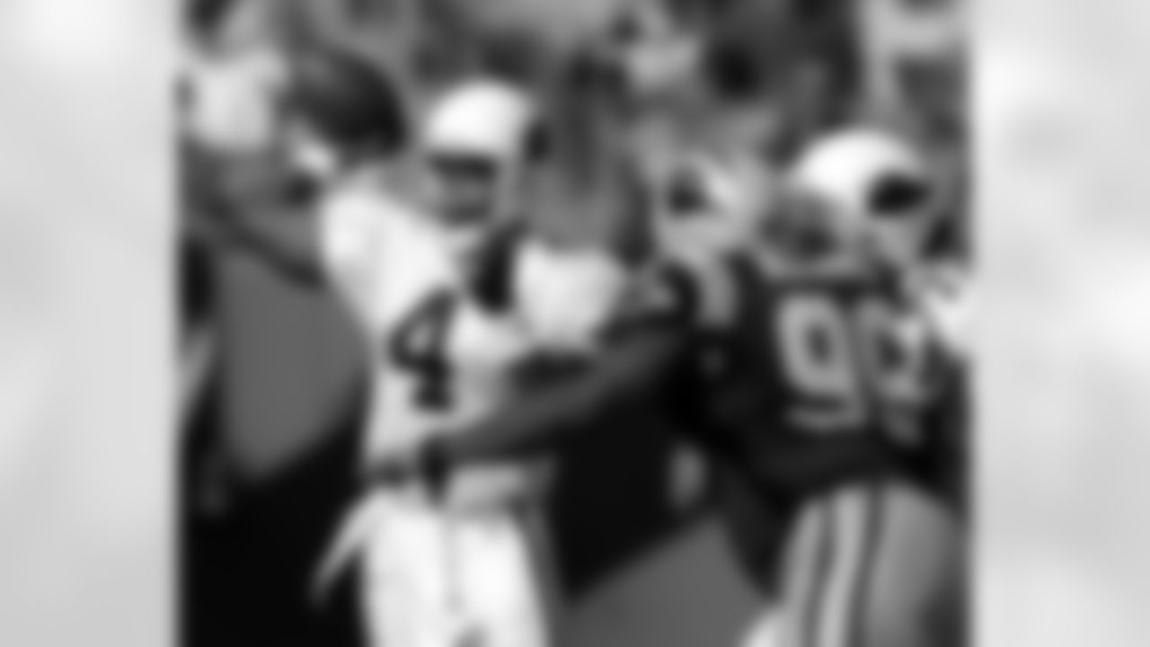 2004: Cardinals QB Shaun King throws a pass as Panthers DT Brentson Buckner closes in