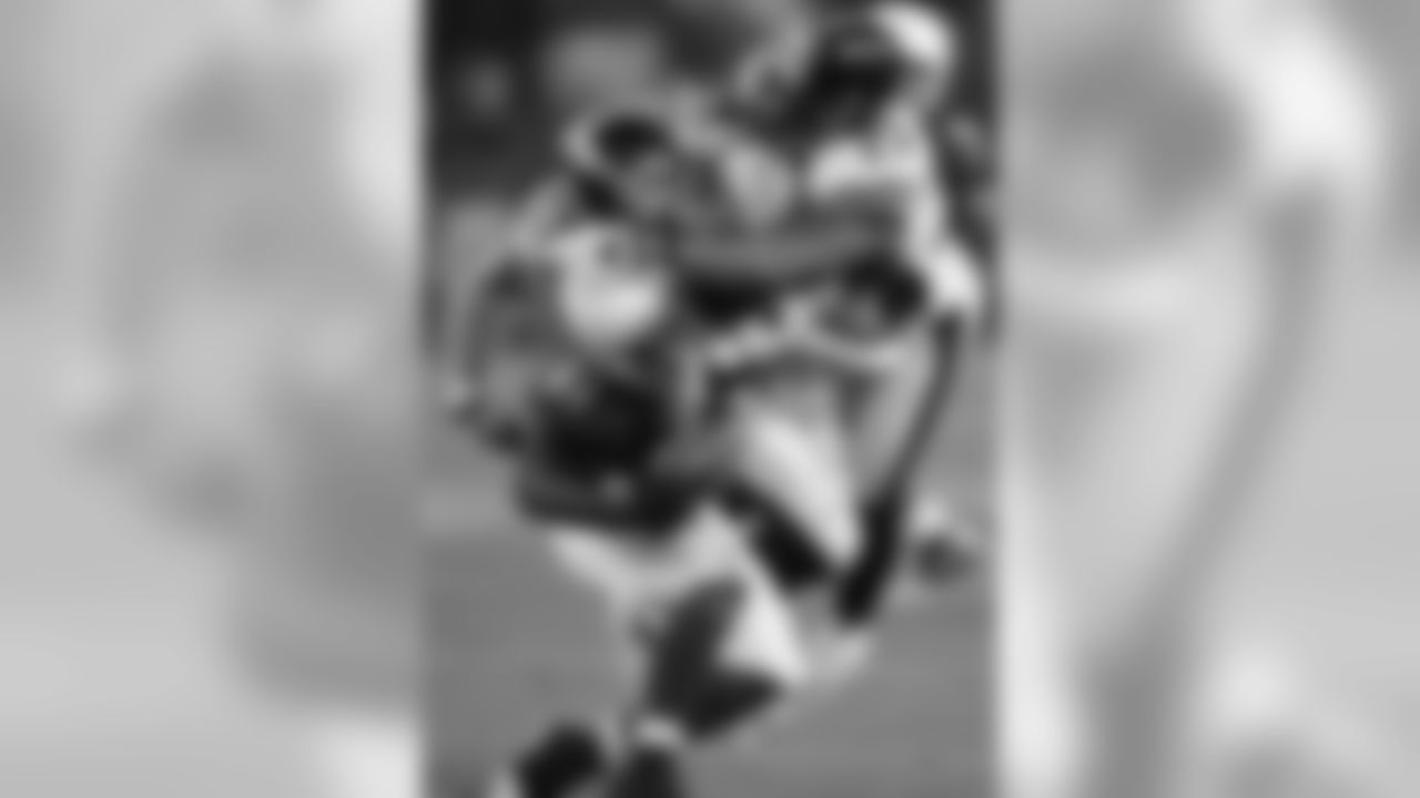 WR Anquan Boldin is tackled by Steelers LB James Farrior and S Ryan Clark